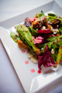 Spring salad with blackberry, candied walnuts, blue cheese crumbles and raspberry vinaigrette