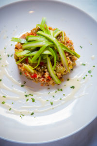 Toasted quinoa with bell peppers, onions, parsley, walnuts, and asparagus in vinaigrette with roasted corn buerre blanc
